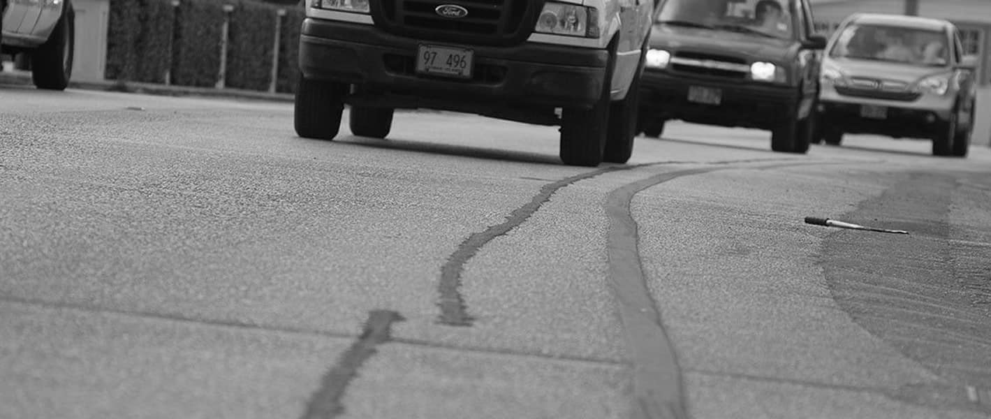 Traffic driving over a utility cut patched with EZ Street